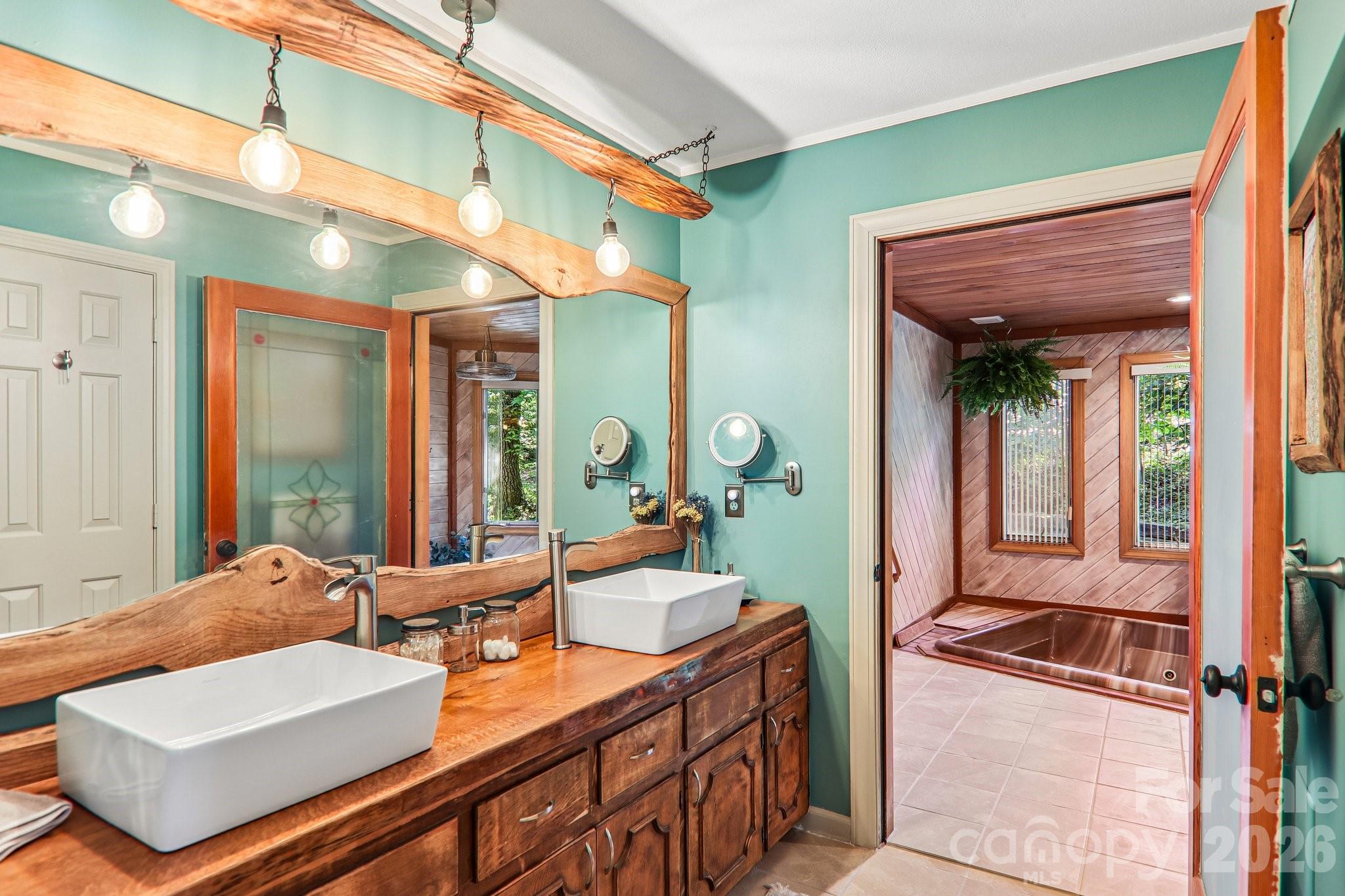 Bathroom in primary bedroom, mountain style details, spa entrance. - 2291 Little River Road, Hendersonville