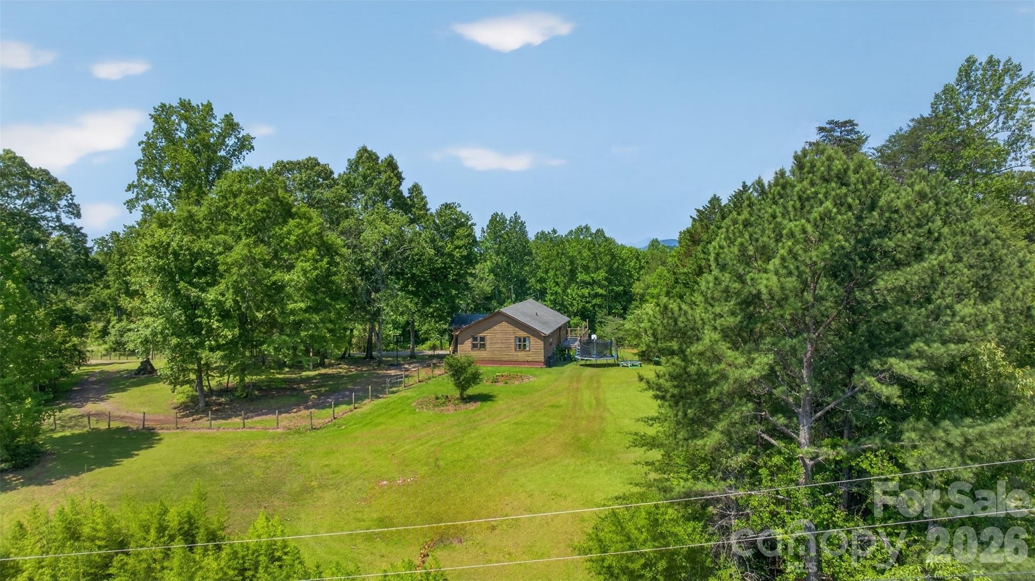 View of right side yard, bordering Robertson Rd. For added convenience can add drive from paved road. - 66 Misery Ridge Trail, Mill Spring