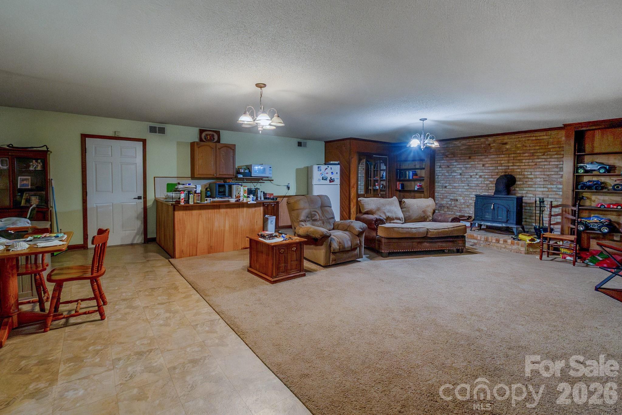 Living area with small kitchenette with garage access - 9205 Richardson King Road, Waxhaw