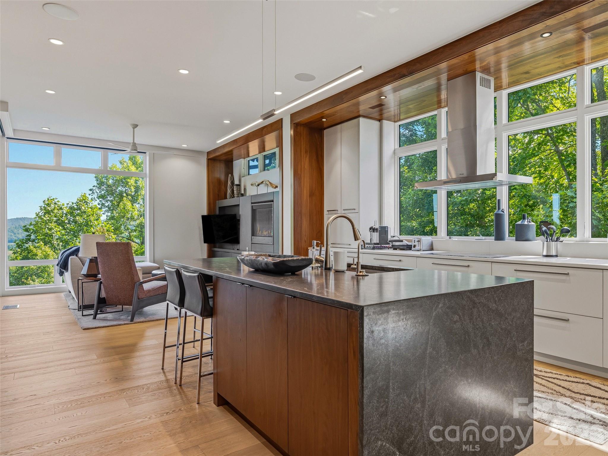 Open-concept living with kitchen, den, and mountain views seamlessly connected - 1121 Timberbluff Way, Arden