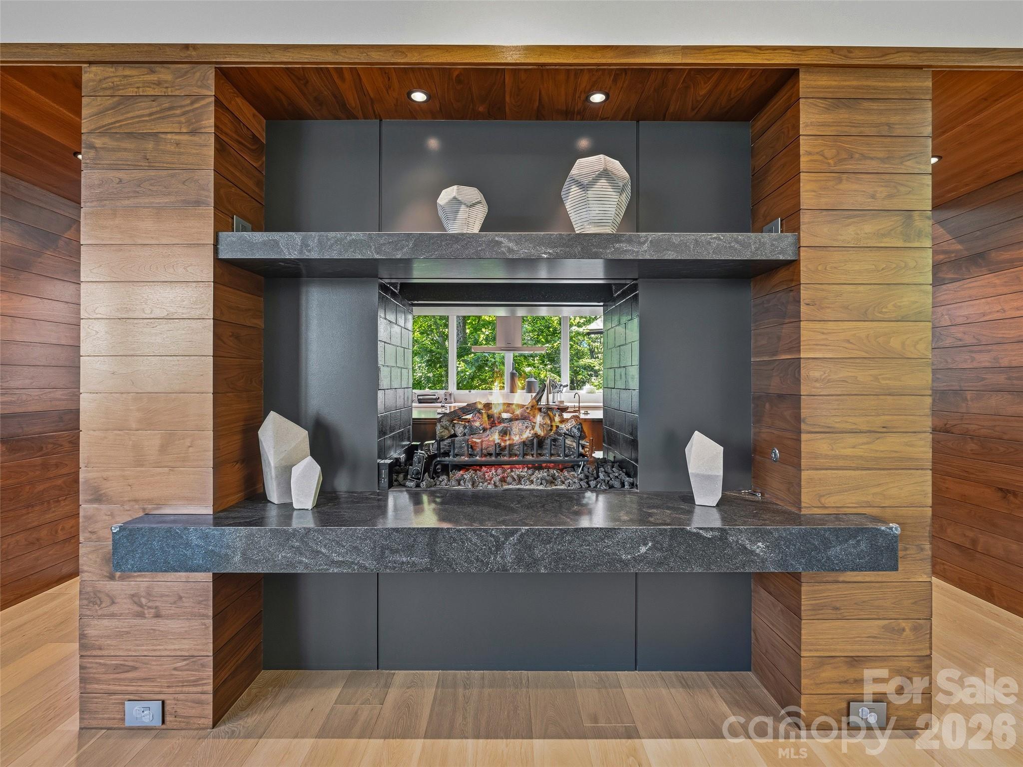 Dramatic see-through fireplace connecting gathering spaces - 1121 Timberbluff Way, Arden