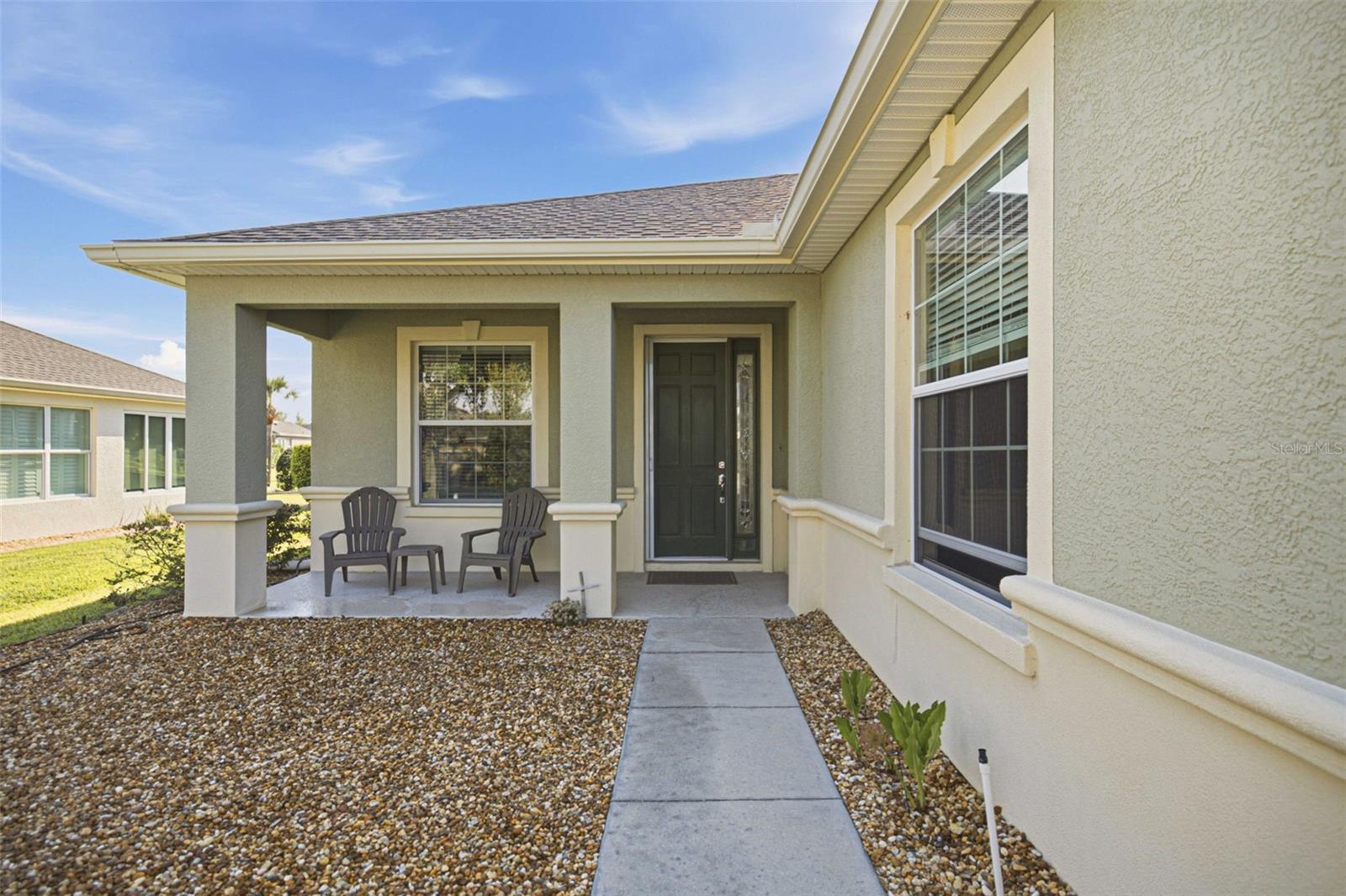 Retractable screen door on covered porch - 6951 SW 94TH CT, OCALA