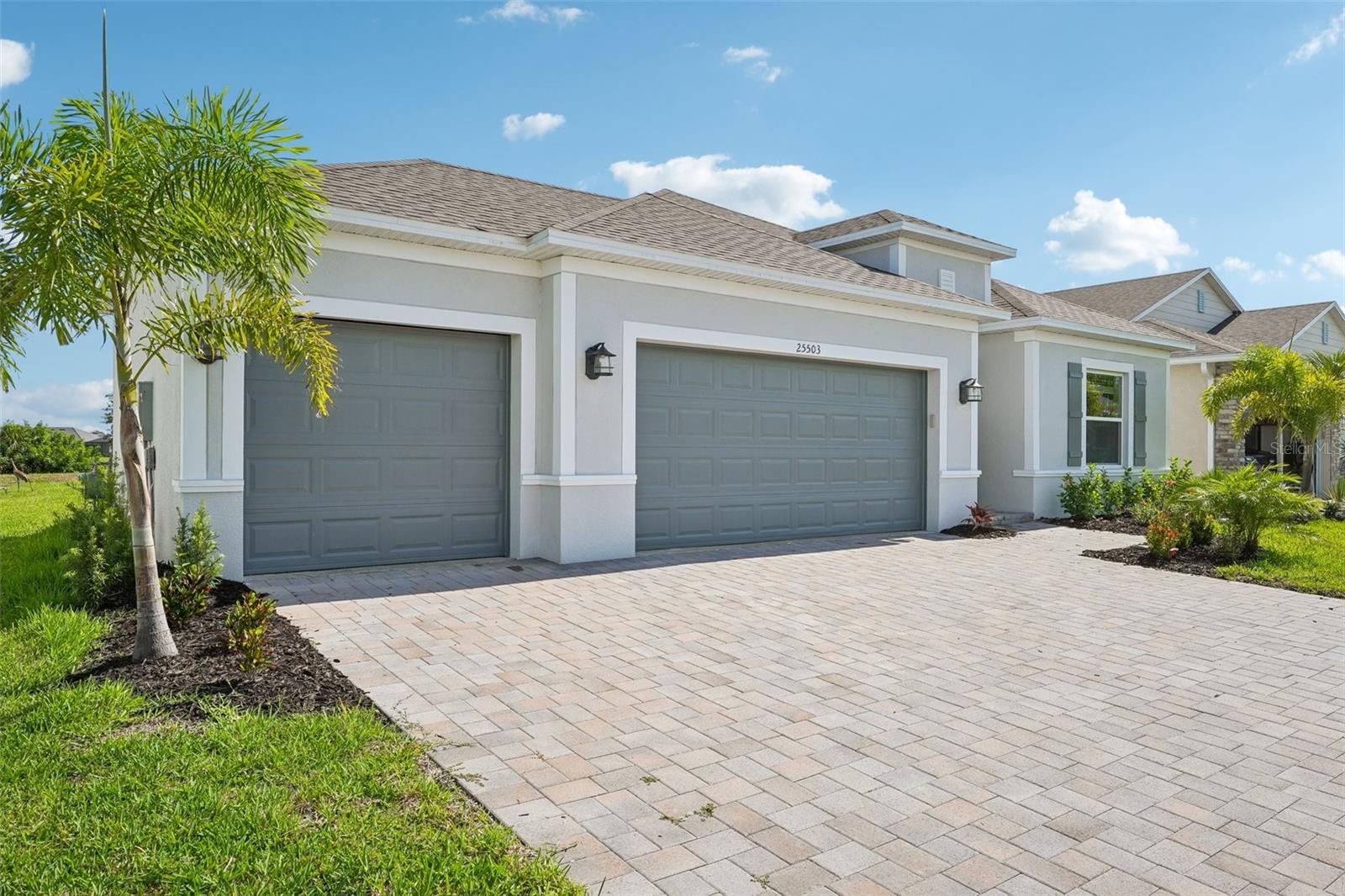 Grand Exterior- Block Construction, 3 car garage, brick pavers, landscaping - 25503 CALUSA DR, PUNTA GORDA