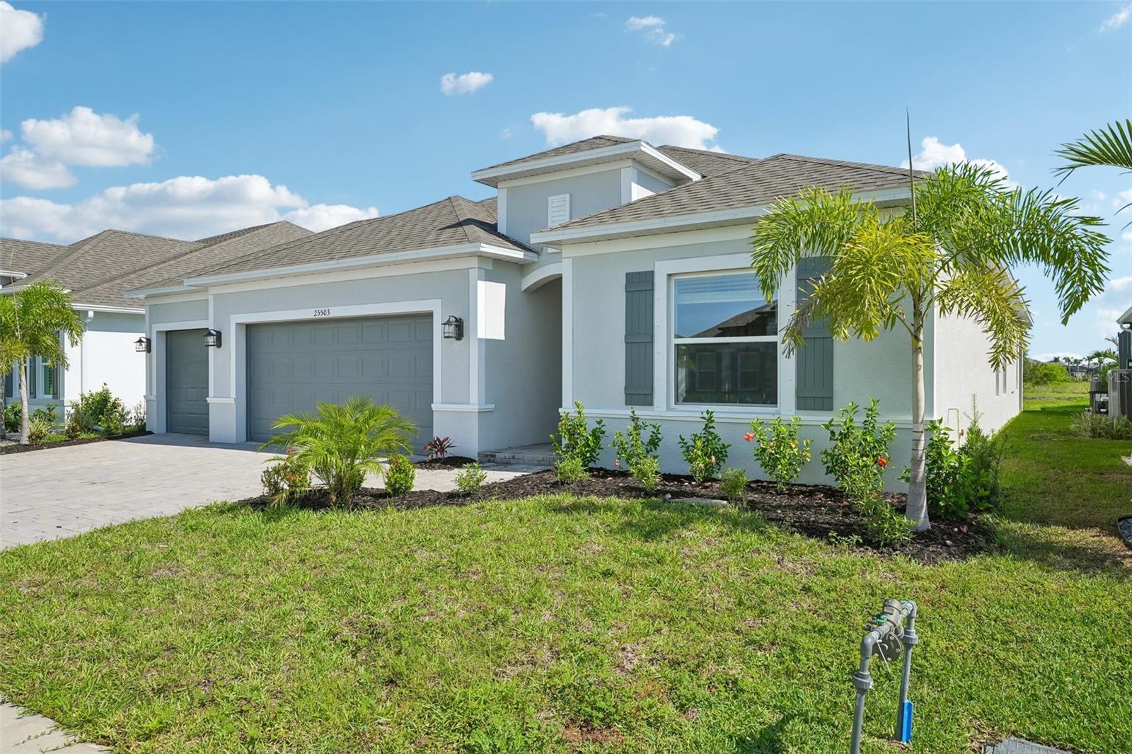 Grand Exterior- Block Construction, 3 car garage, brick pavers, landscaping - 25503 CALUSA DR, PUNTA GORDA
