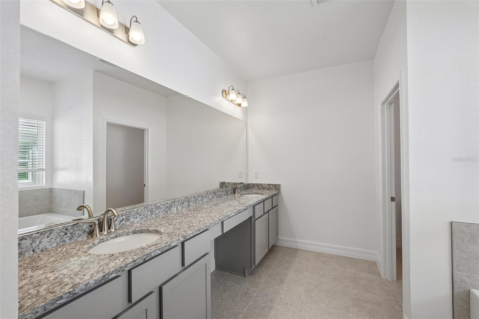 Primary Bath Granite Countertops, Tile Shower, Separate Tub, Dual Vanities - 25503 CALUSA DR, PUNTA GORDA