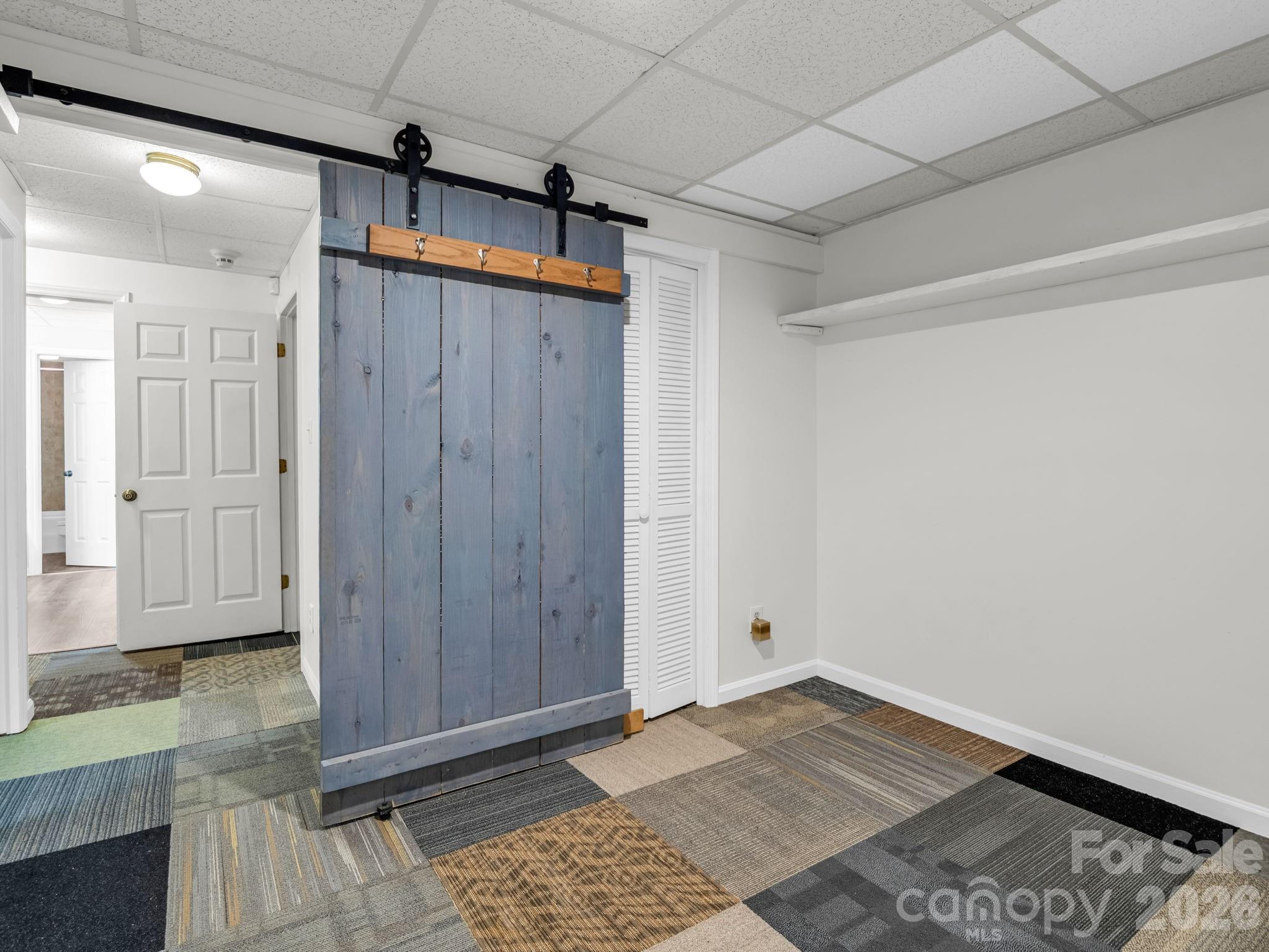Small bonus room between hall and basement workshop and garage - 1810 Arbor Way Drive, Shelby