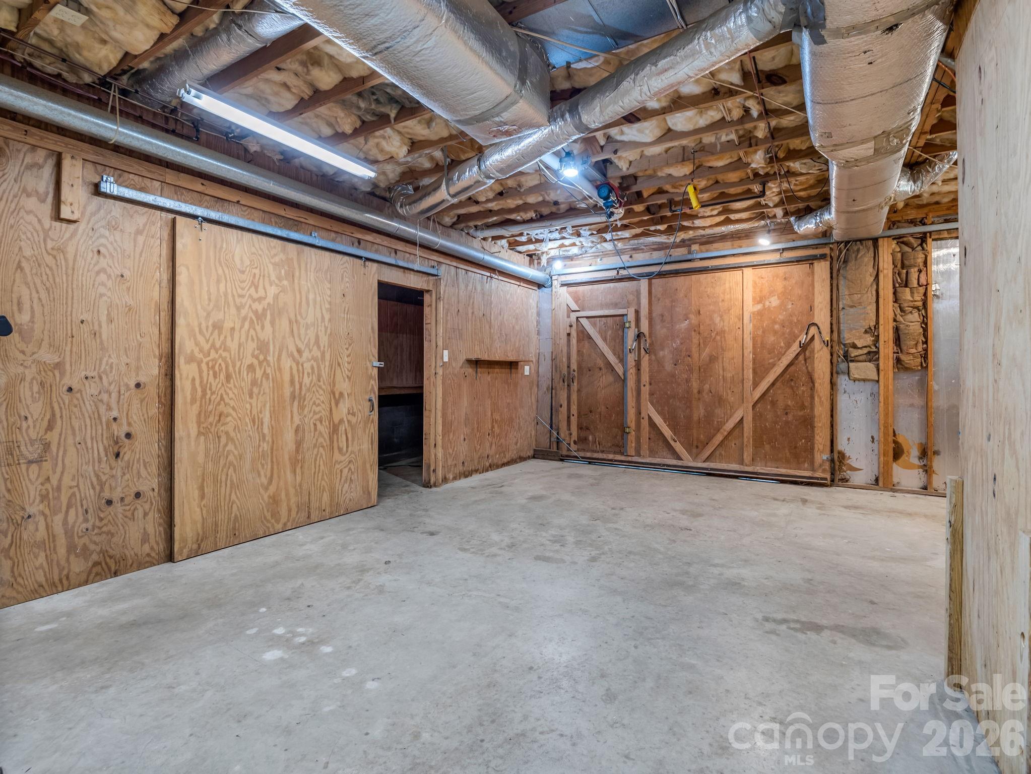 Large storage to left side and sliding garage door to outside and driveway - 1810 Arbor Way Drive, Shelby