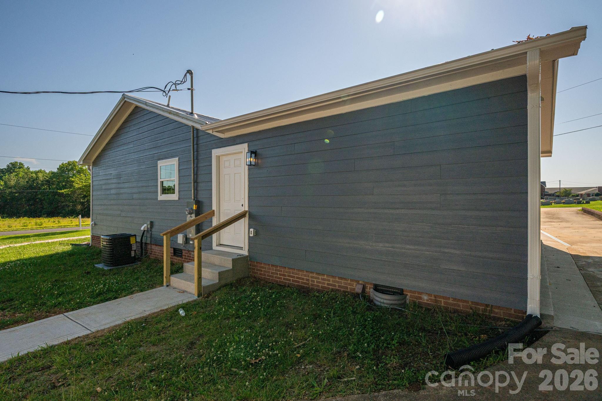 Newly poured concrete walkway leads to the side entrance. - 6123 Flay Road, Cherryville