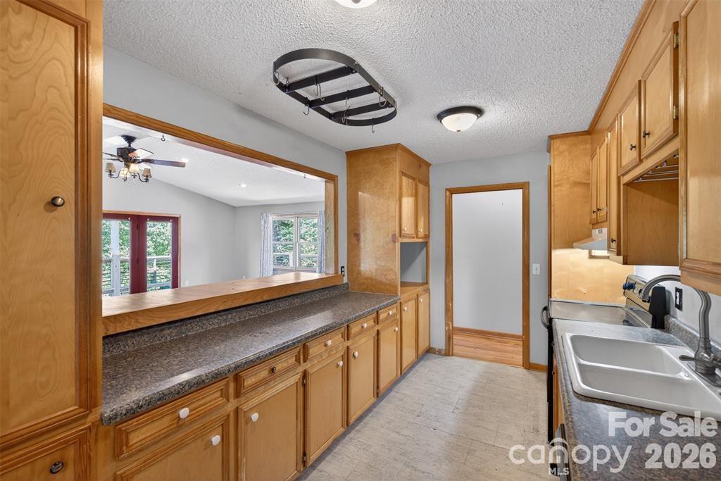 Galley kitchen for easy access of ample cabinetry. - 00 Misery Ridge Trail, Mill Spring