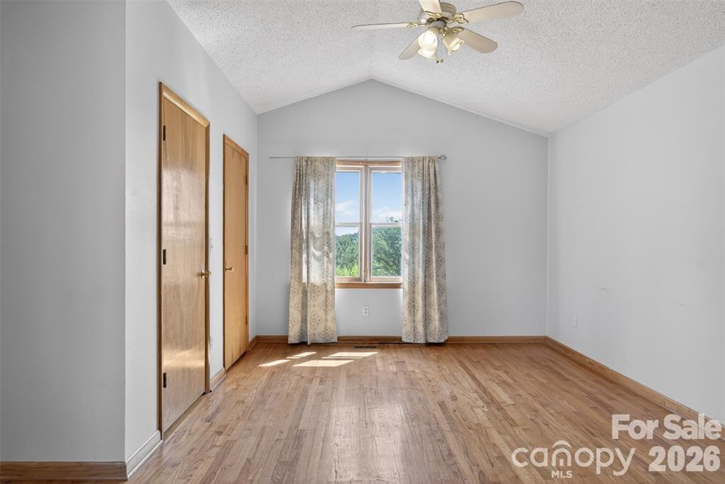 Primary suite with cathedral ceiling has ensuite bath. - 00 Misery Ridge Trail, Mill Spring