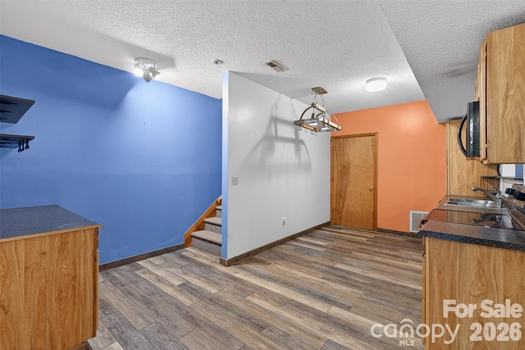View 2 of kitchen. Door showing is access to one of the bonus rooms. - 00 Misery Ridge Trail, Mill Spring