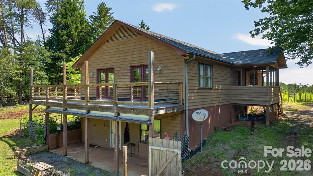 Side view shows entry to downstairs apartment. - 00 Misery Ridge Trail, Mill Spring