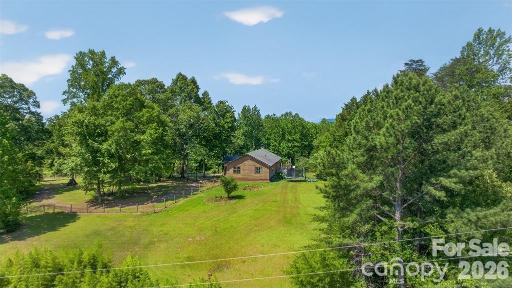 View of right side yard that borders Robertson Rd. For added convenience, can add drive from paved road. - 66 Misery Ridge None, Mill Spring
