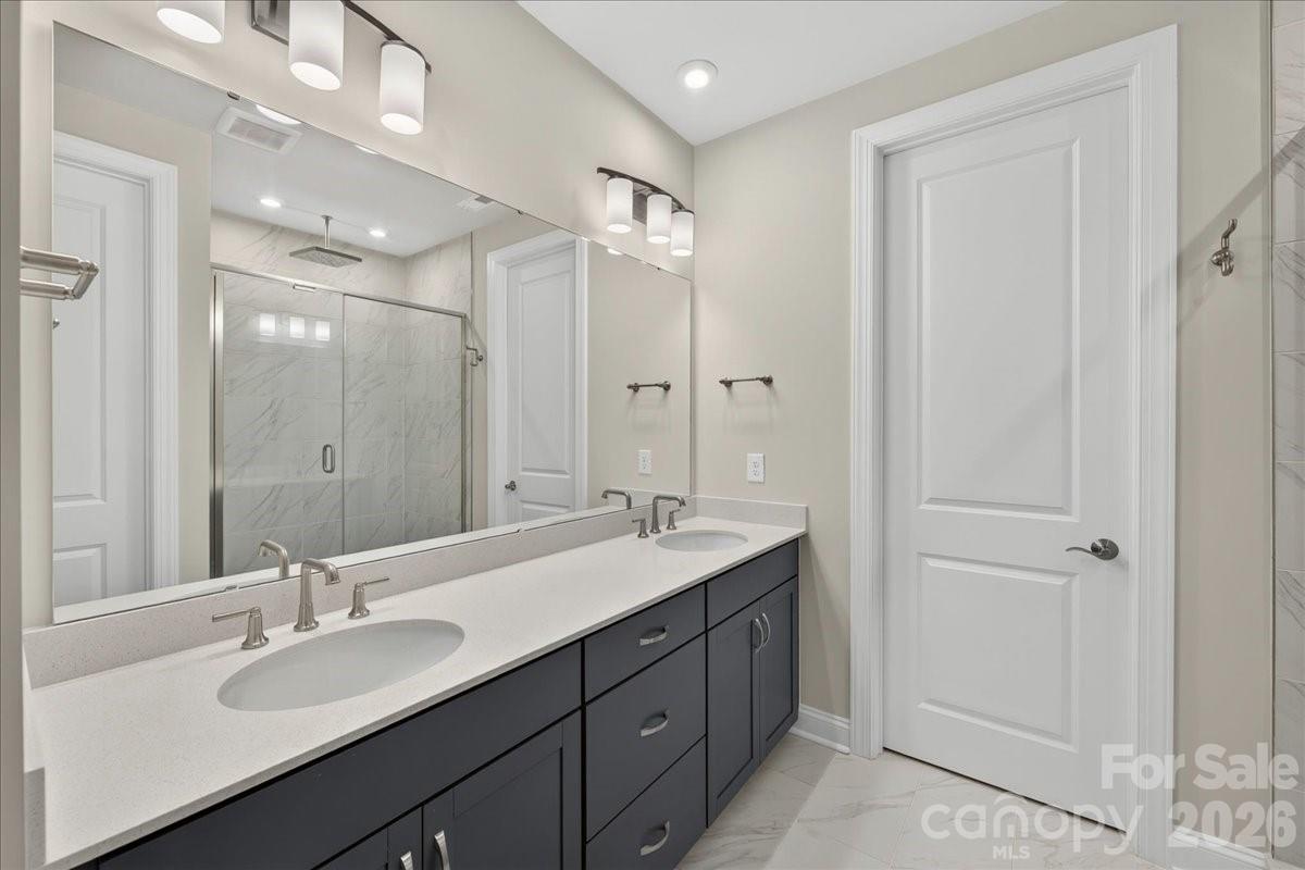 Dual vanity primary bathroom with cabinets with drawers - 232 Old Town Village Road, Waxhaw