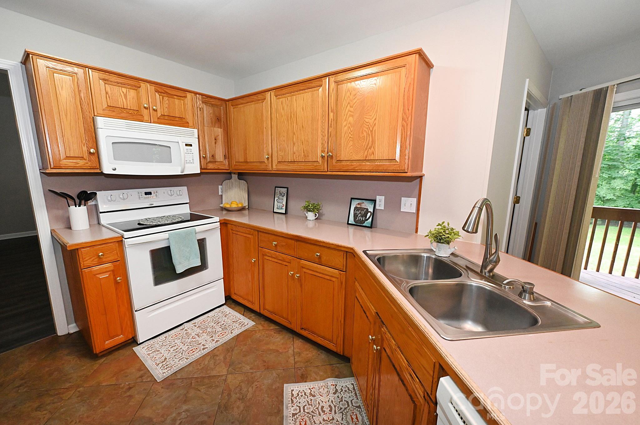 Behind this kitchen is a bonus room that be be used as an office, hobby room, game room etc. - 1035 E 24th Street, Newton