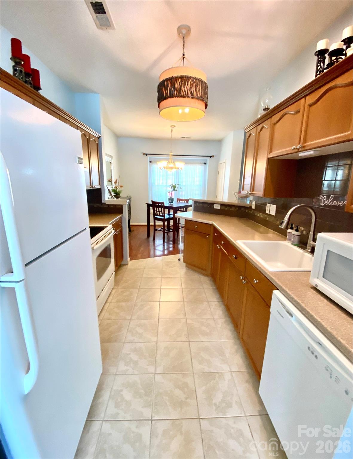 Kitchen view into Dining Area. Countertop microwave. - 6025 Creft Circle, Indian Trail
