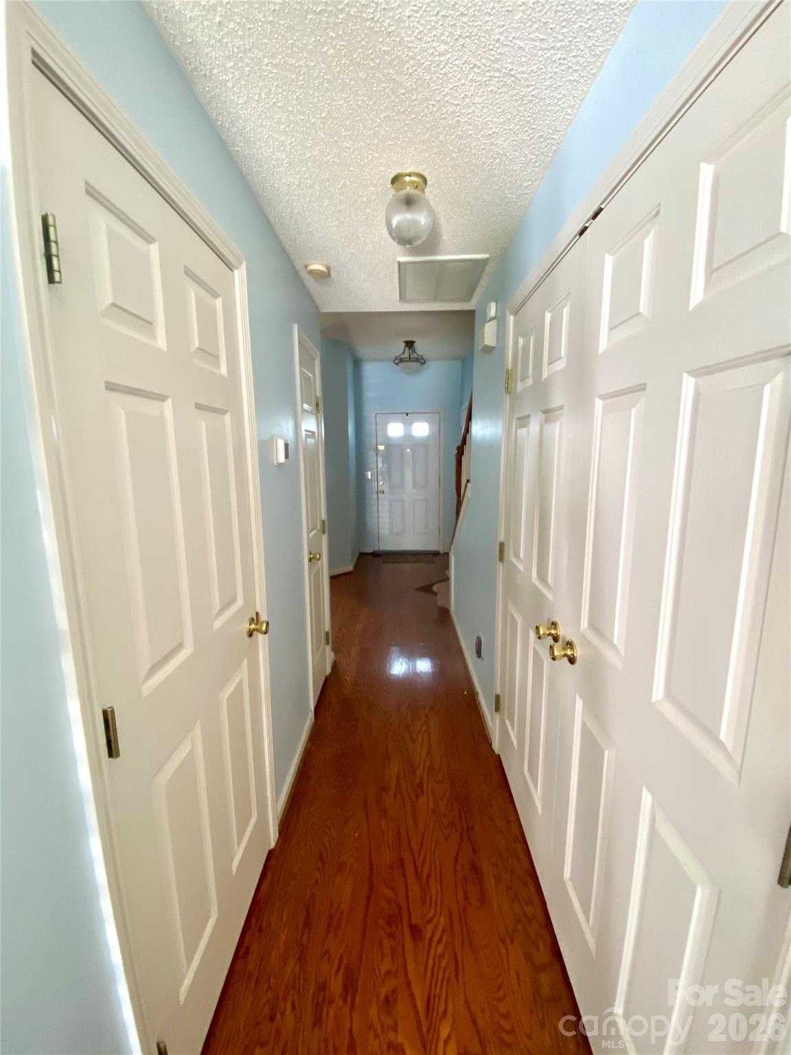 Hallway with Laundry closet on the right, 1/2 Bath on the left and linen closet also on the left. - 6025 Creft Circle, Indian Trail