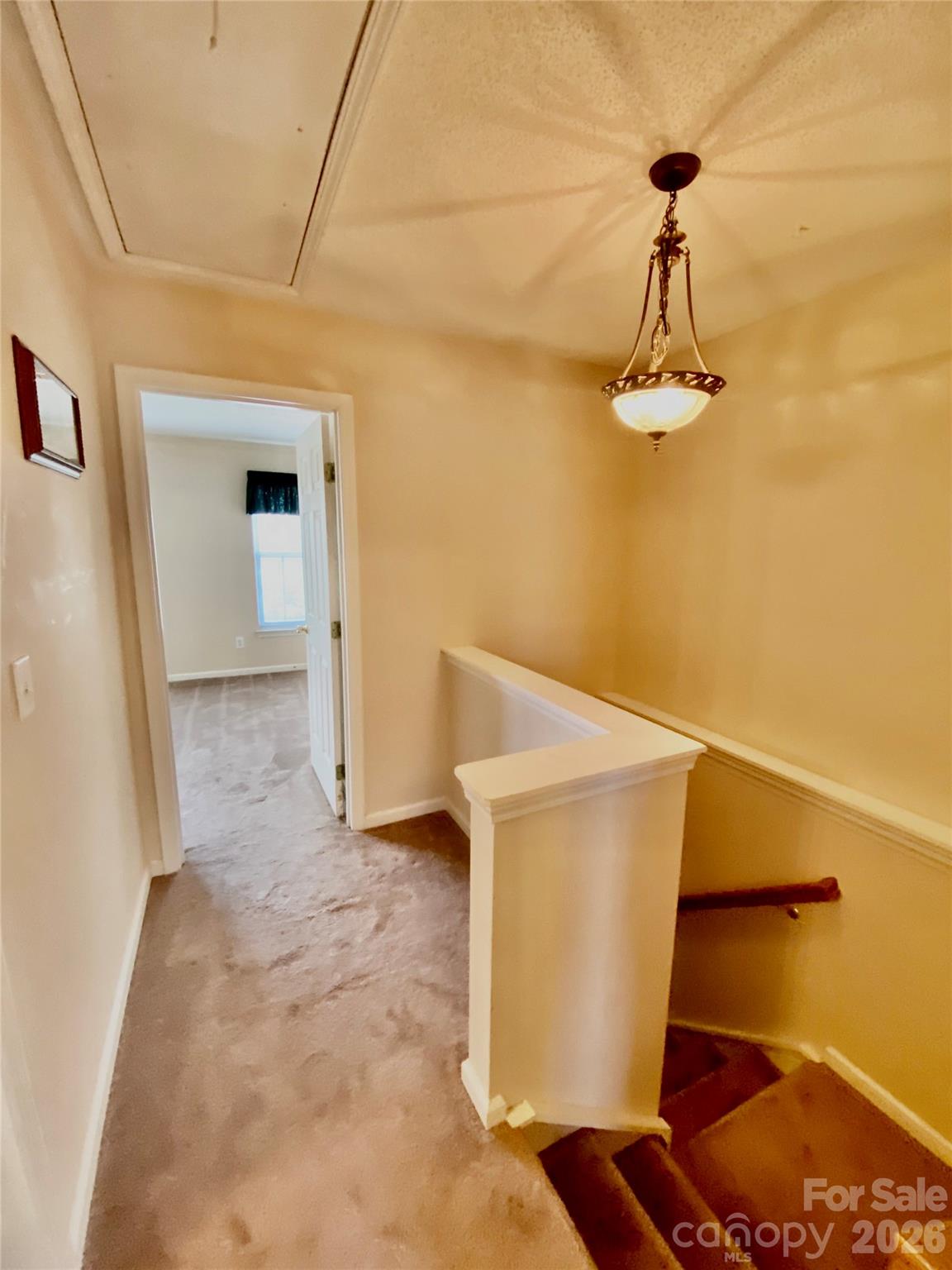 Upstairs Hallway niche area on the right, pull down attic stairs and door to the Secondary Bedroom. - 6025 Creft Circle, Indian Trail