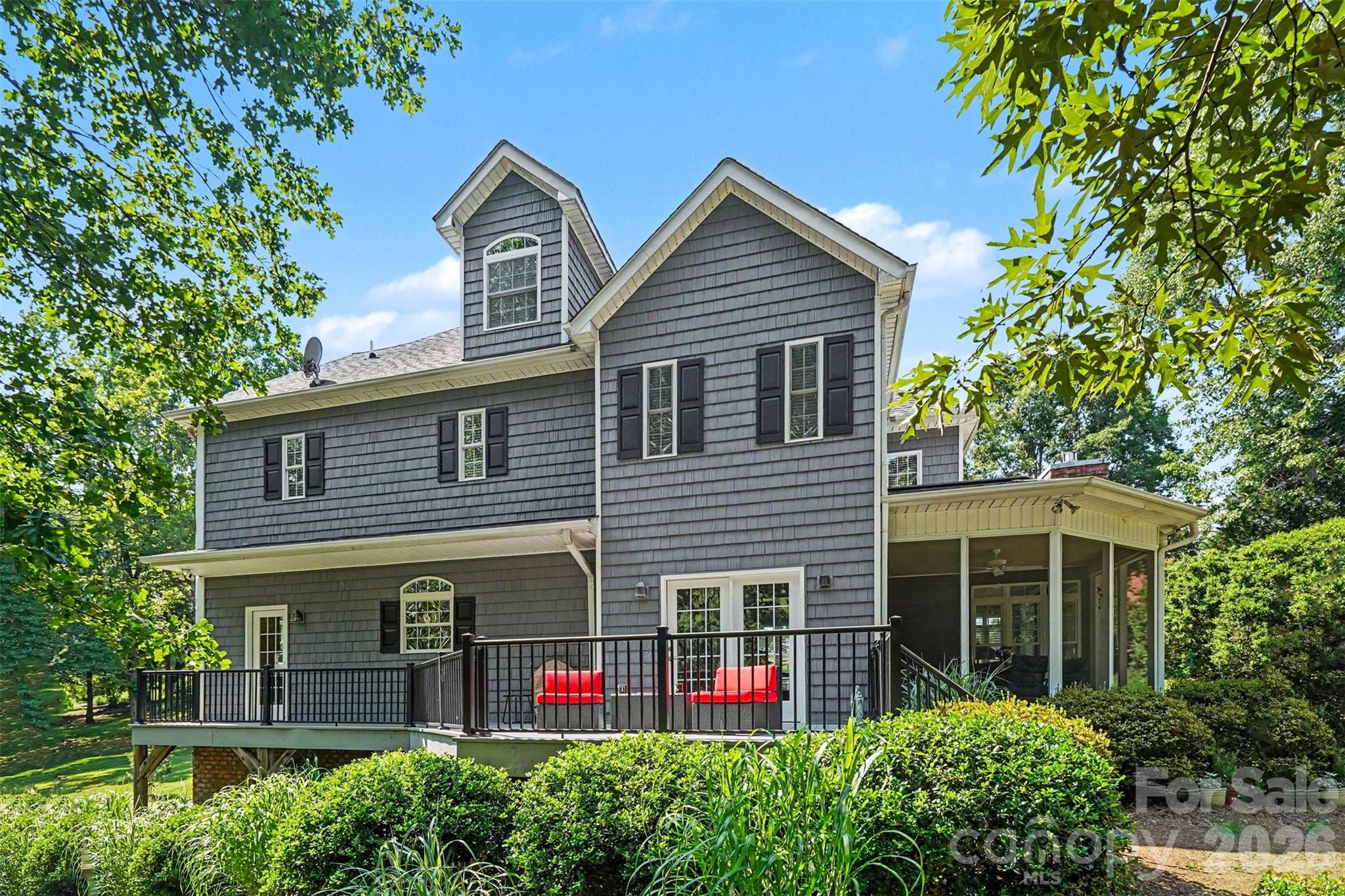 Rear view of the home with it's deck and screened porch - 162 Twin Lakes Drive, Statesville