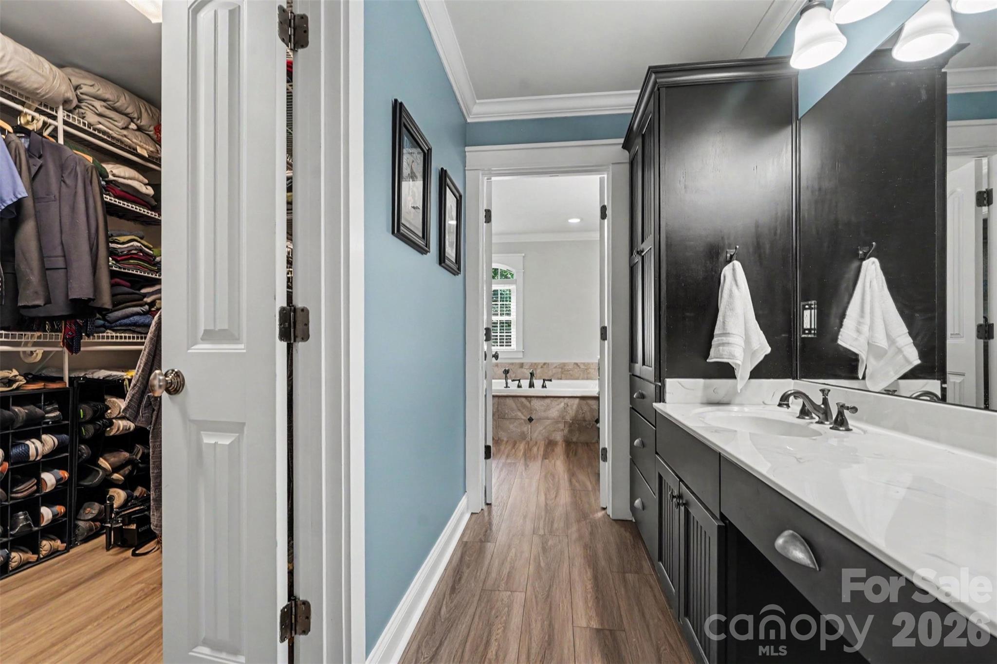 Primary bath with dual vanities and a large walk in closet - 162 Twin Lakes Drive, Statesville
