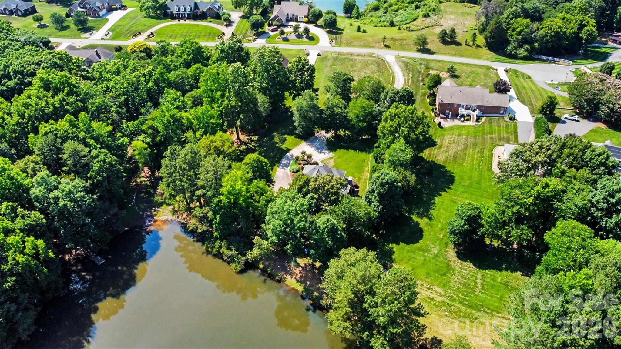 Aerial view of the property and the pond - 162 Twin Lakes Drive, Statesville