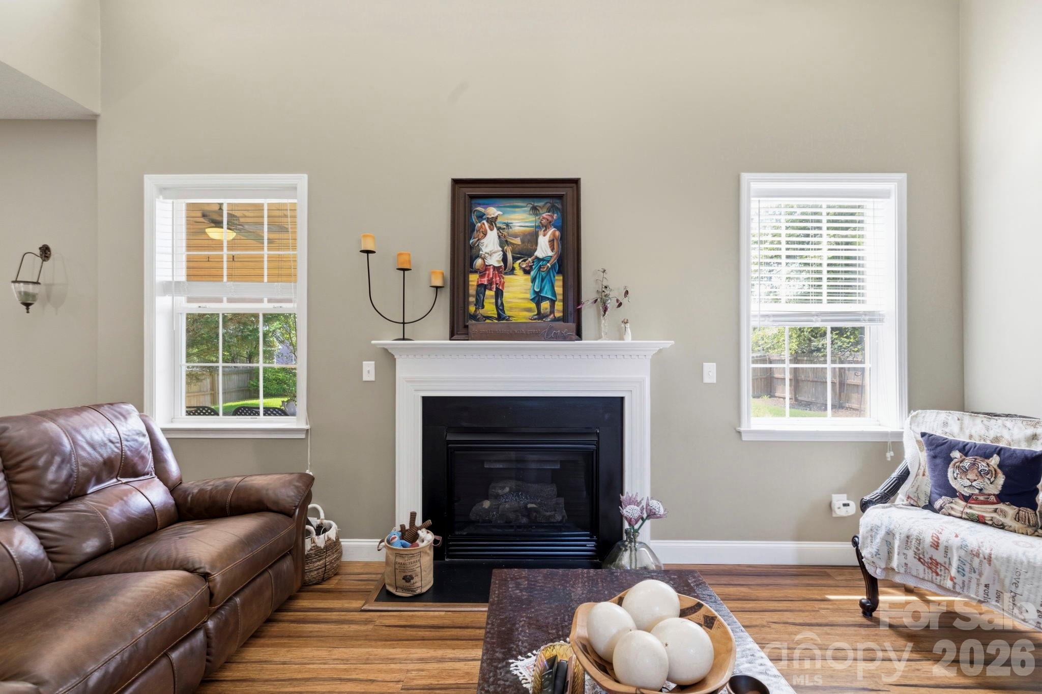 Cozy living area centered around a gas fireplace, highlighted by tall ceilings and abundant natural light. - 266 Wildbriar Road, Fletcher