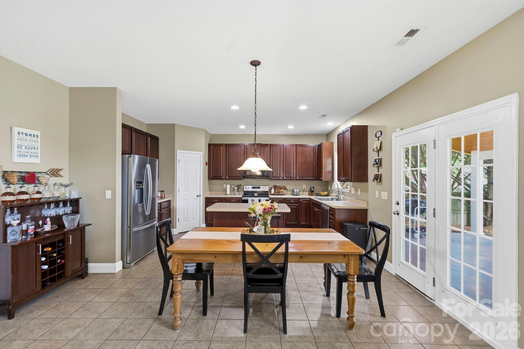 Open dining space adjacent to the kitchen with easy access to the covered patio for indoor-outdoor entertaining. - 266 Wildbriar Road, Fletcher