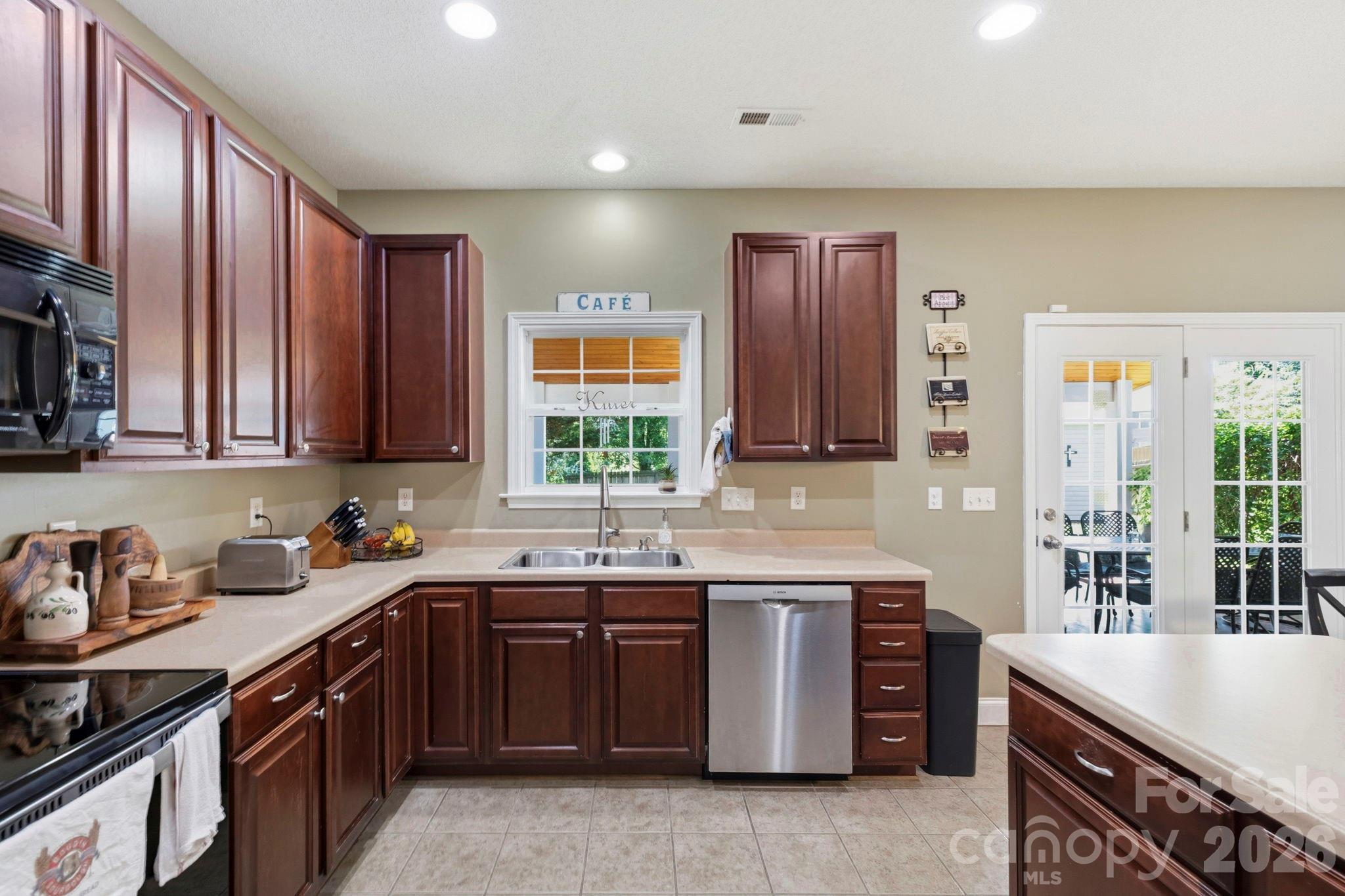 Well-appointed kitchen with extensive counter space, stainless steel appliances, and convenient layout for everyday living. - 266 Wildbriar Road, Fletcher