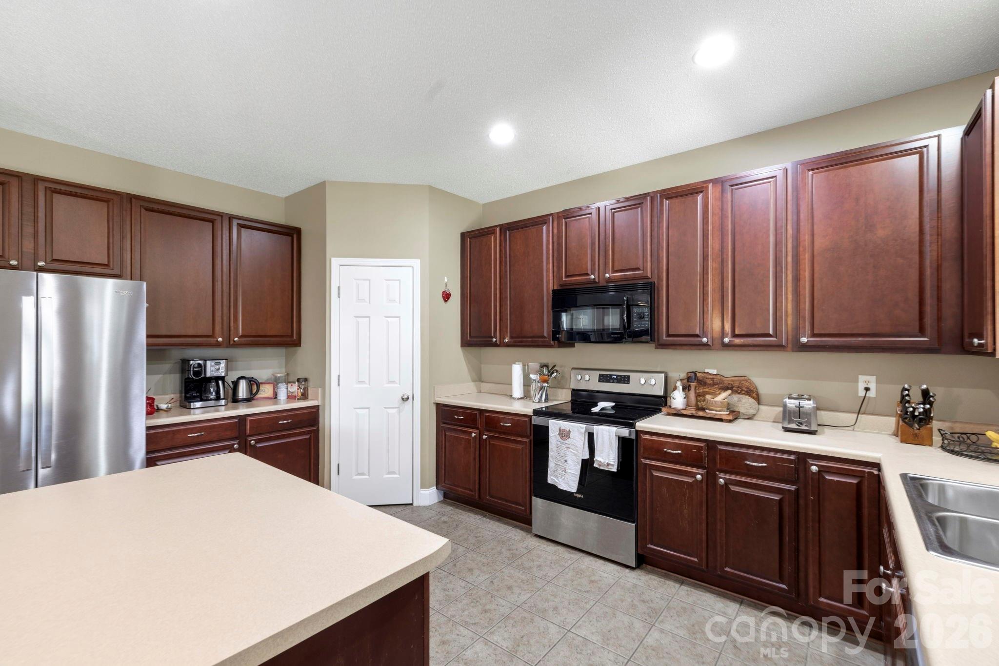 Large kitchen offering generous cabinet storage, prep island, and plenty of workspace for cooking and entertaining. - 266 Wildbriar Road, Fletcher