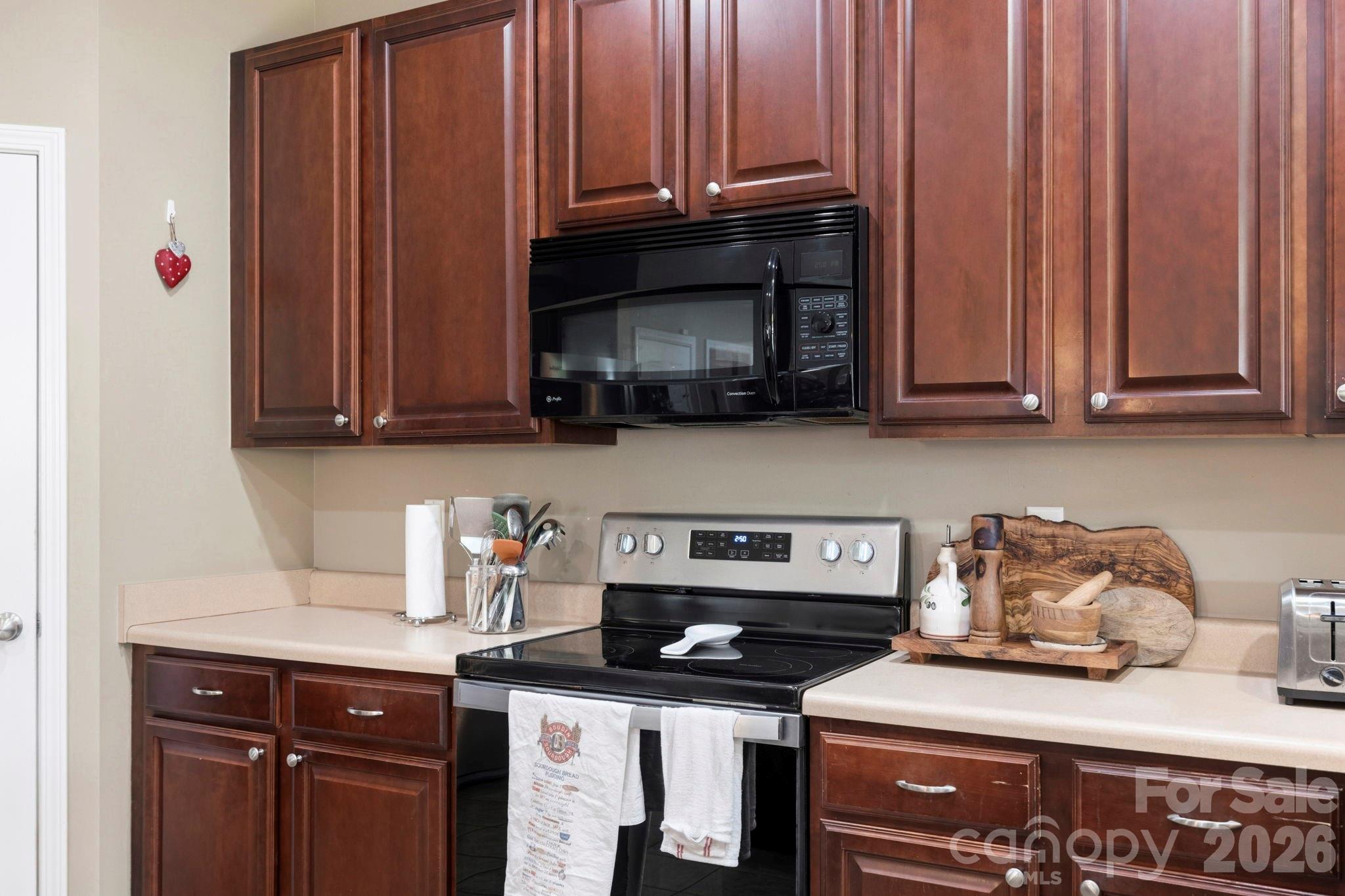 Functional kitchen workspace with ample cabinetry, modern appliances, and durable low-maintenance surfaces. - 266 Wildbriar Road, Fletcher