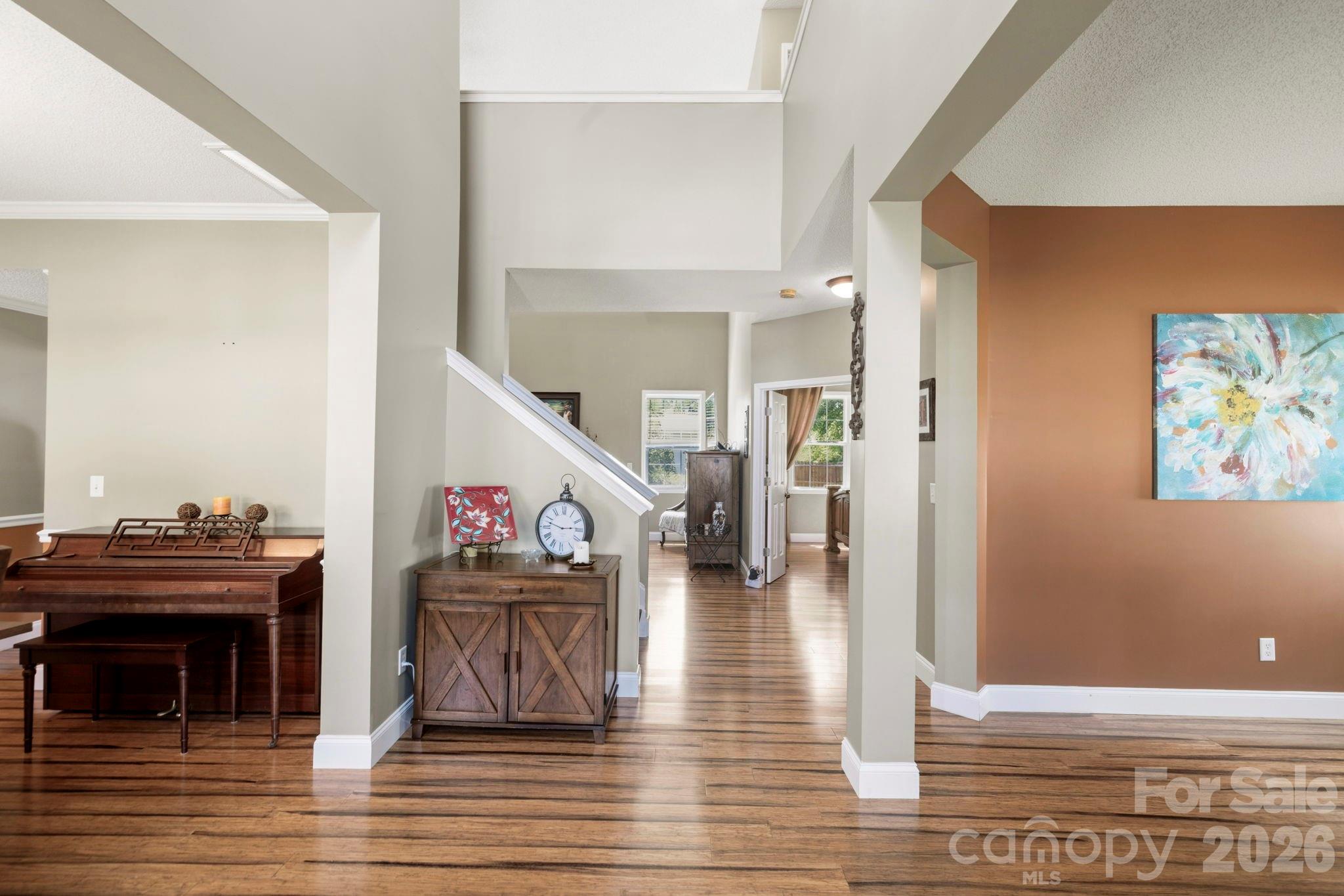 Welcoming two-story foyer with soaring ceilings, abundant natural light, and durable wood-look flooring throughout the main level. - 266 Wildbriar Road, Fletcher