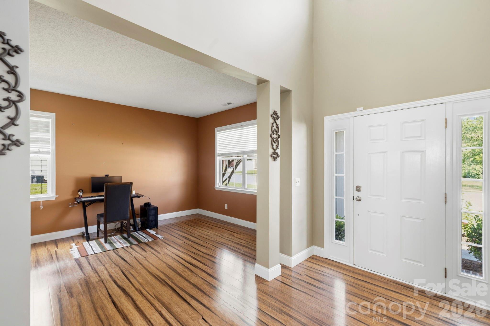 Bright entryway opening to a versatile flex room ideal for a home office, sitting room, or formal living area. - 266 Wildbriar Road, Fletcher