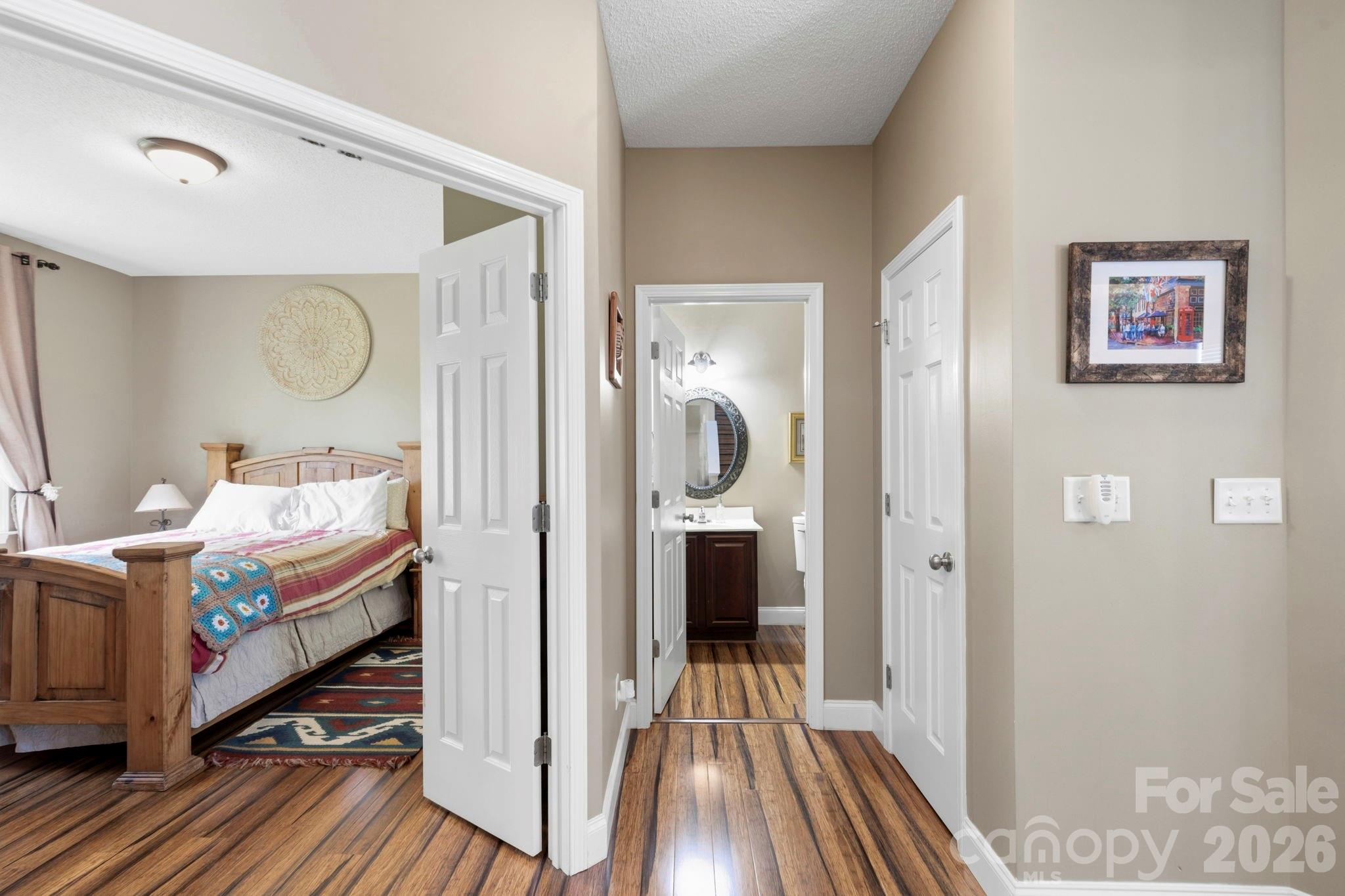 Convenient main-level bedroom entry featuring private half-bath access and ample storage nearby. - 266 Wildbriar Road, Fletcher