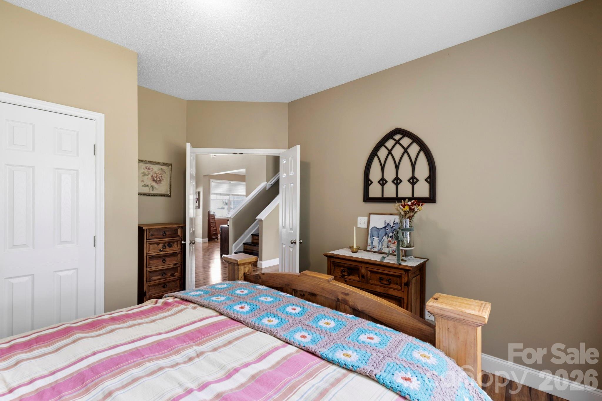 Spacious bedroom with ample wall space, neutral finishes, and convenient access to nearby bath and living areas. - 266 Wildbriar Road, Fletcher