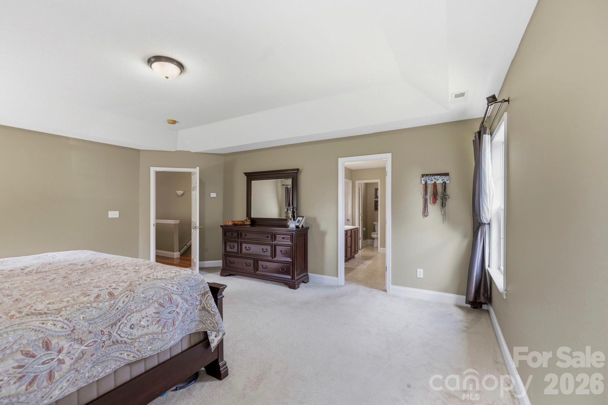 Expansive owner's retreat with generous floor space, elegant furnishings, and direct access to the private en-suite bathroom. - 266 Wildbriar Road, Fletcher