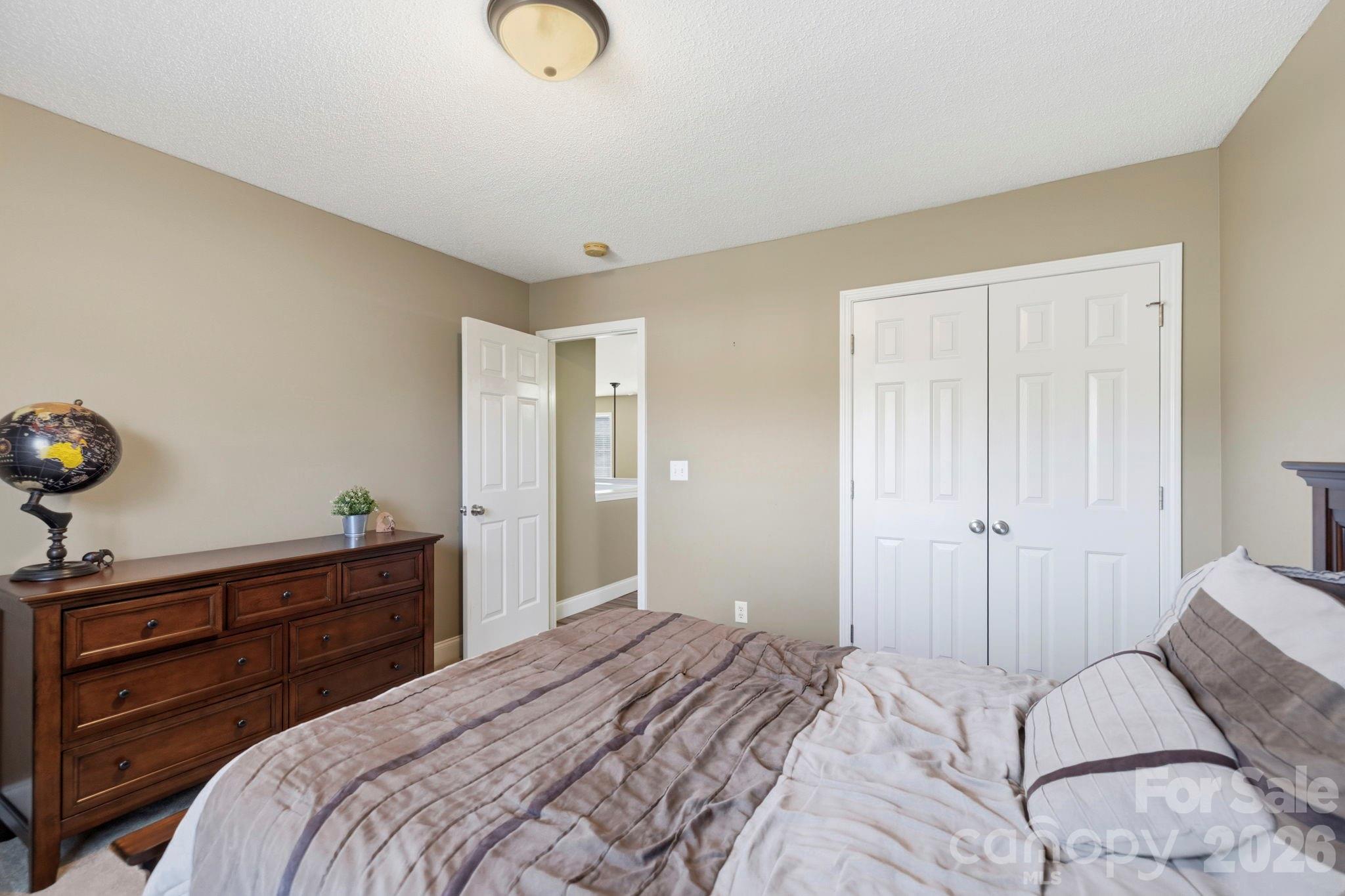 Secondary bedroom featuring generous closet storage and bright, airy finishes throughout. - 266 Wildbriar Road, Fletcher