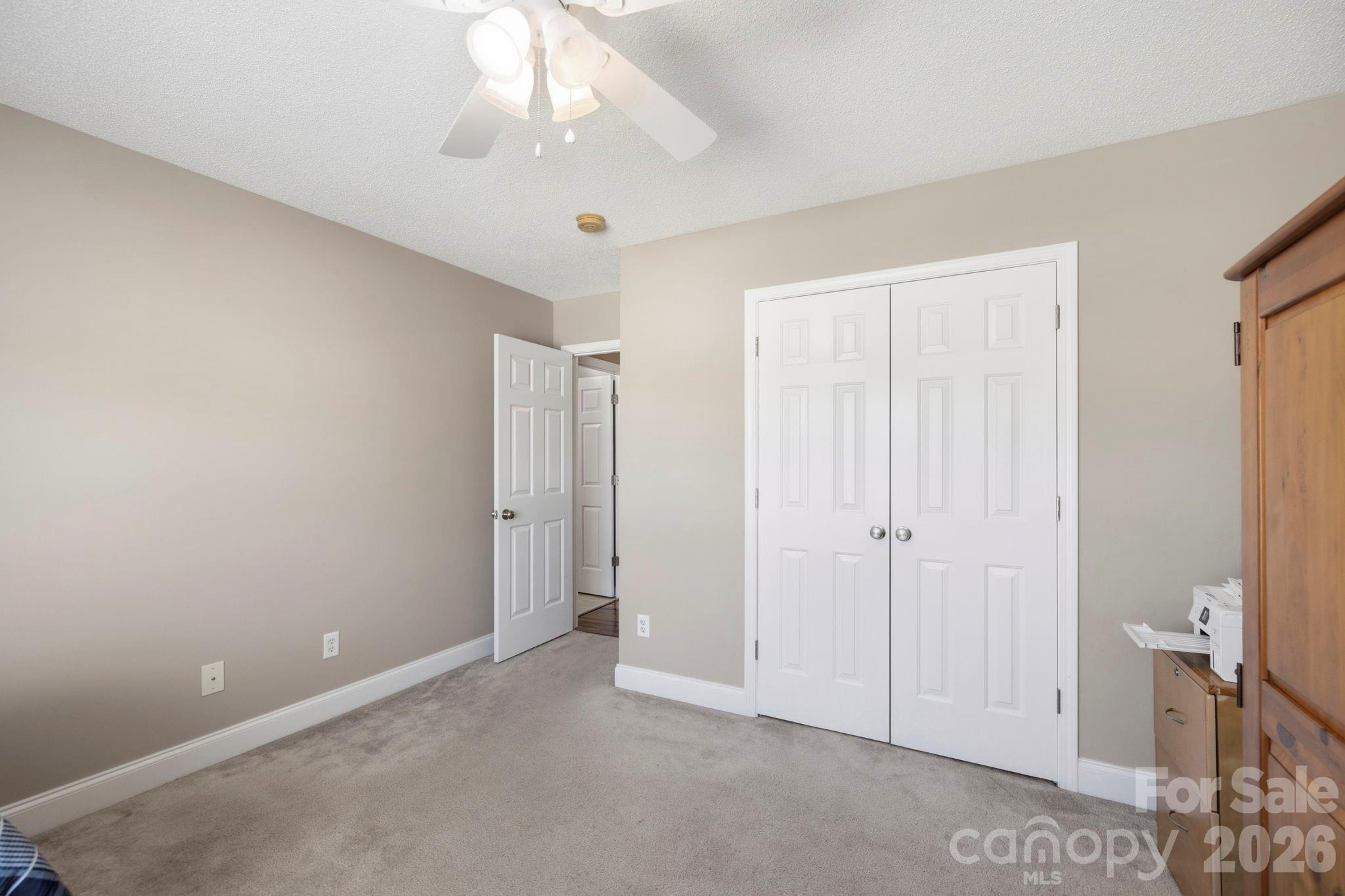 Well-sized bedroom with generous closet space, ceiling fan, and easy access to the upper-level hall bath. - 266 Wildbriar Road, Fletcher