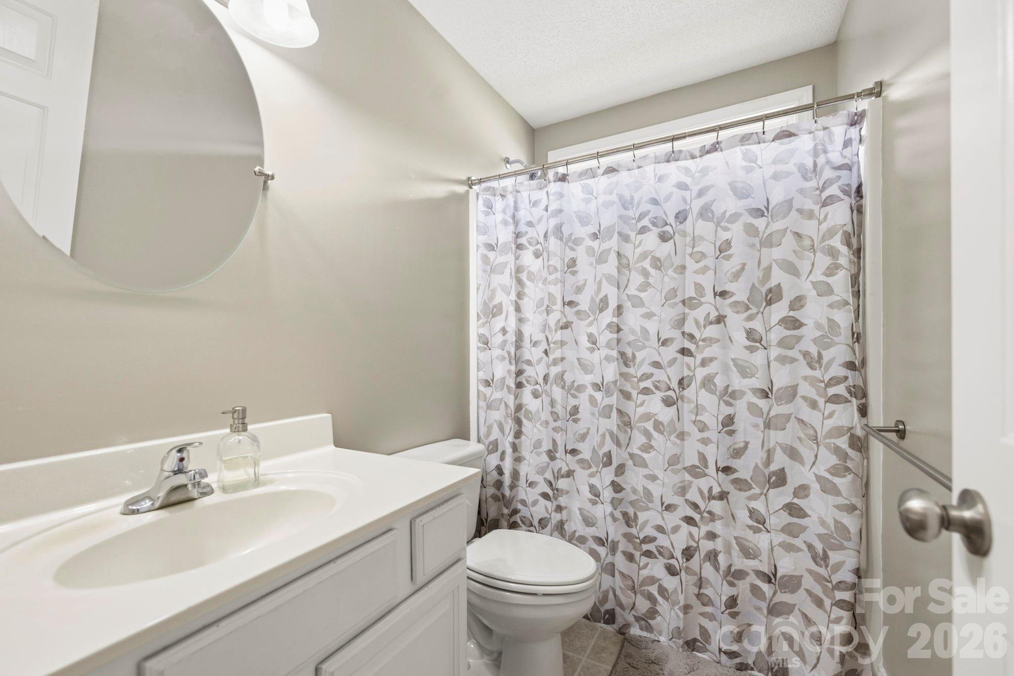 Full bathroom with vanity, tub/shower combination, and convenient access to nearby secondary bedrooms. - 266 Wildbriar Road, Fletcher