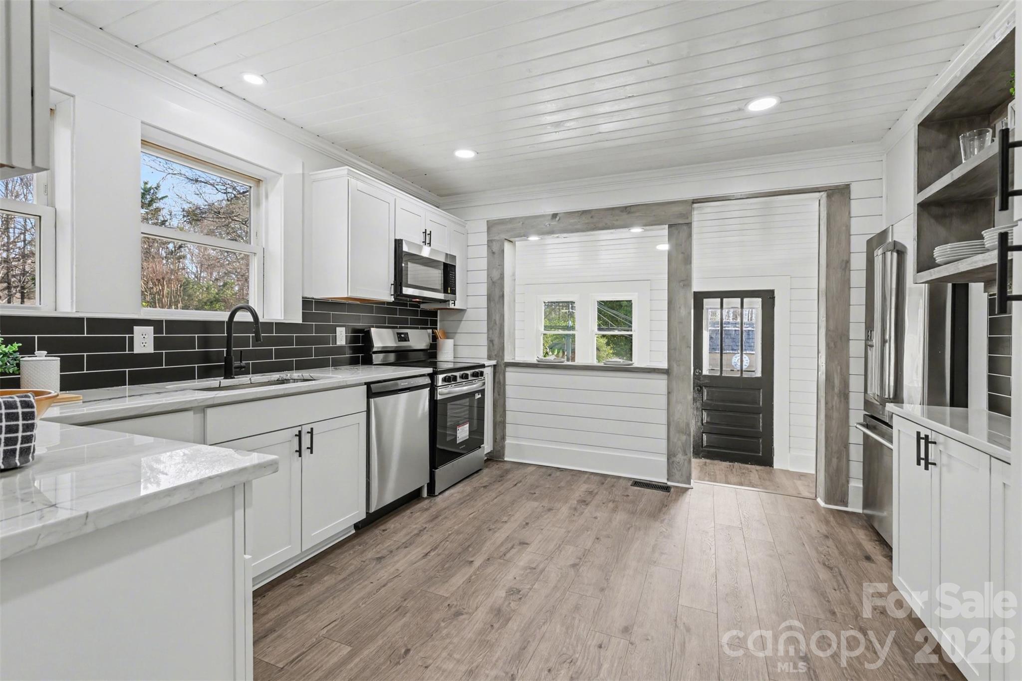 Kitchen has enough space to add a butcher block island. Pantry and wine/barista or serving bar to the right, so versatile. The bar to the right of the range is lower on the other side to add bar stools too! - 622 Neelys Creek Road, Rock Hill