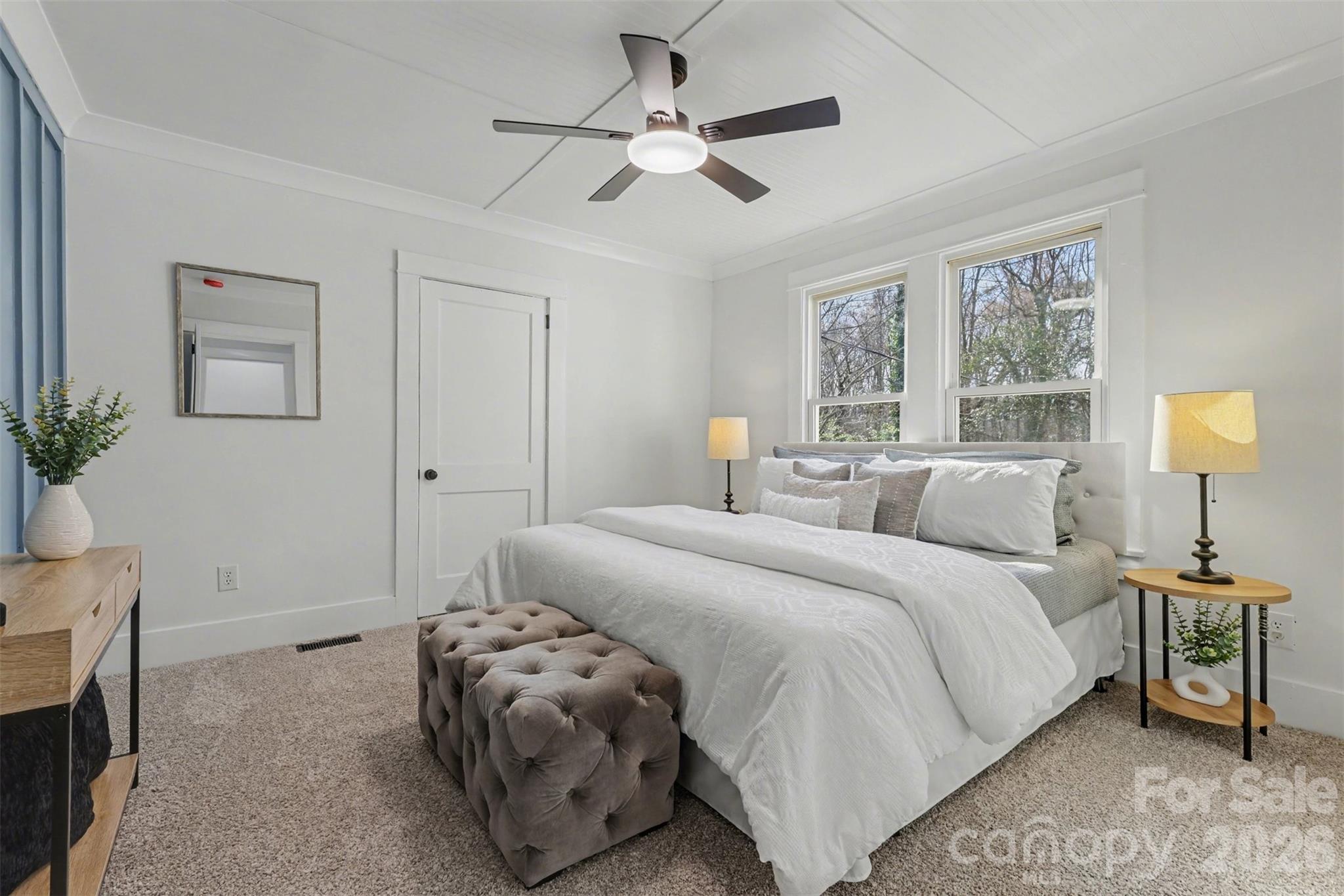 Spacious primary bedroom with a nice size walk in clsoet. Look at the detail onthe ceiling and wall..the original doors were left to sustain the lure of the the country home charm - 622 Neelys Creek Road, Rock Hill