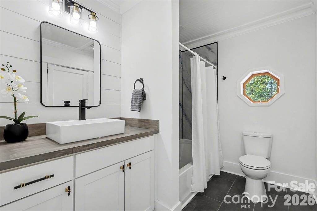Hall bath with marble surround in the shower/tub, new countertop, fixtures, and tiled flooring..nothing left overlooked - 622 Neelys Creek Road, Rock Hill