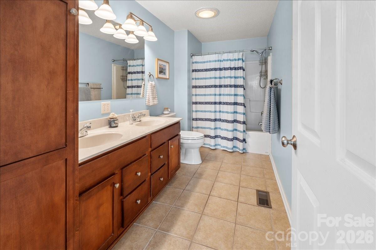 Primary bath with tile floors and lots of cabinetry - 104 Balsam Circle, Troy