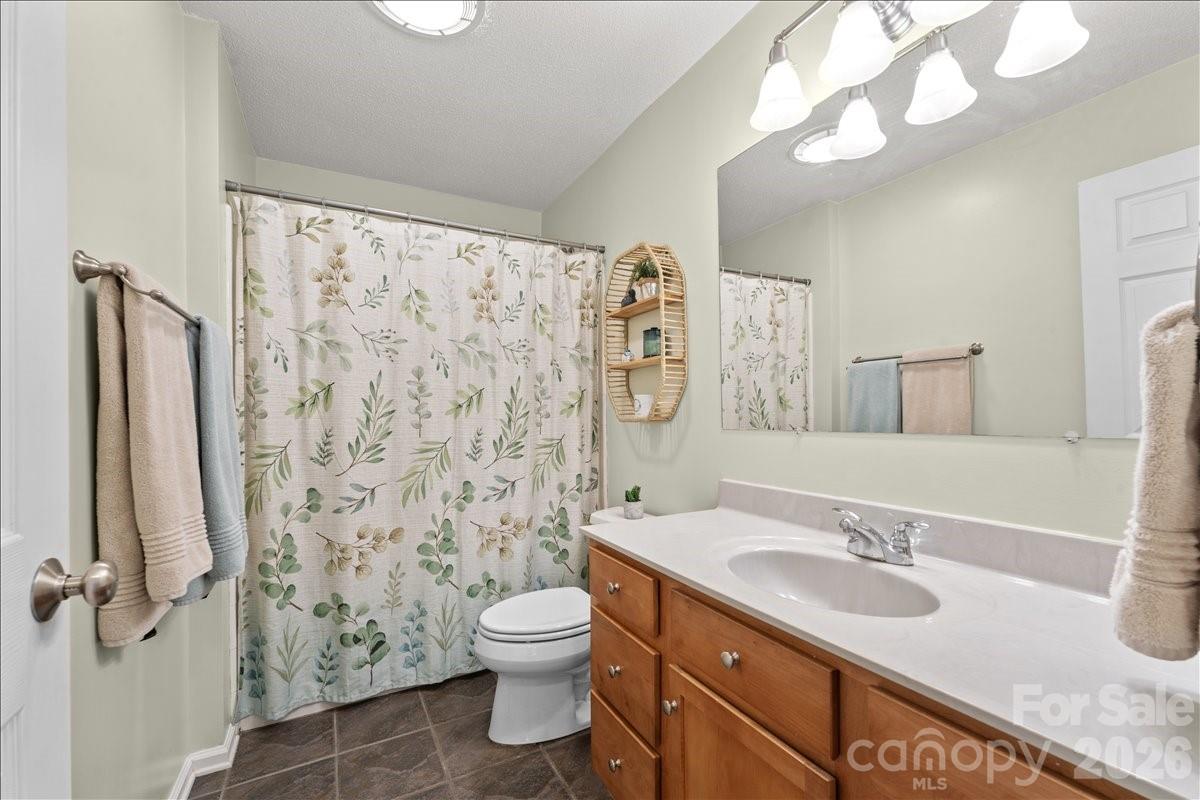 Upstairs hall bath has tile flooring and nice cabinets. - 104 Balsam Circle, Troy