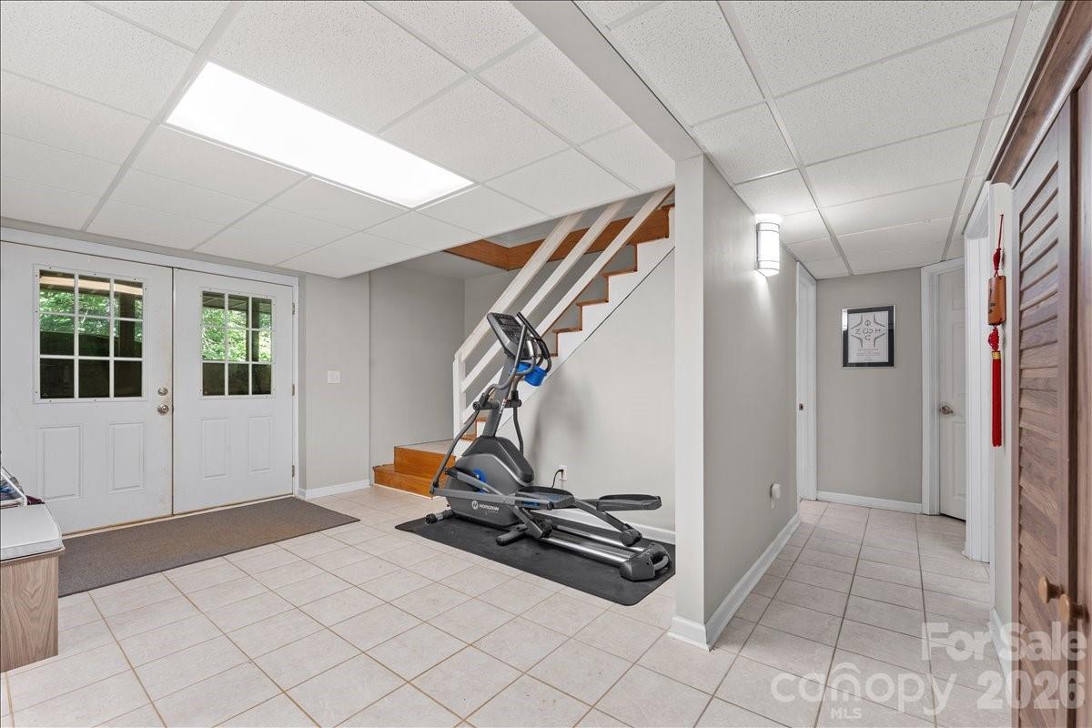 The downstairs entrance from upstairs is a spacious tiled area with access to the outside through the double doors. - 104 Balsam Circle, Troy