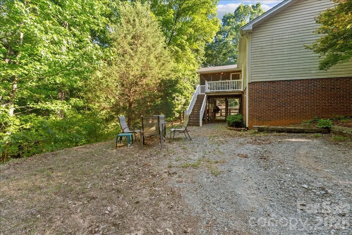 Back view.  The basement entrance is under the deck and porch. - 104 Balsam Circle, Troy