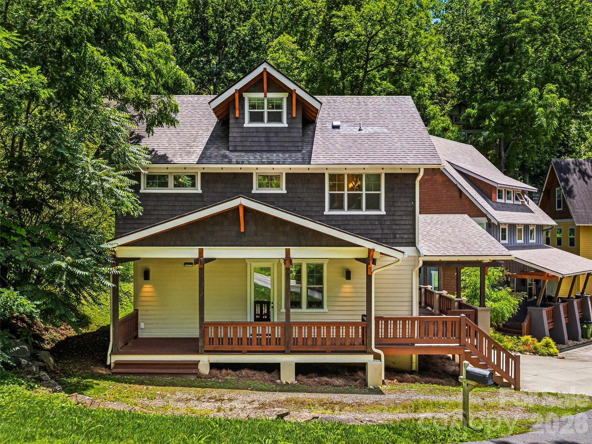 Charming curb appeal featuring a spacious covered wrap-around front porch. - 25 Shady Park Lane, Asheville