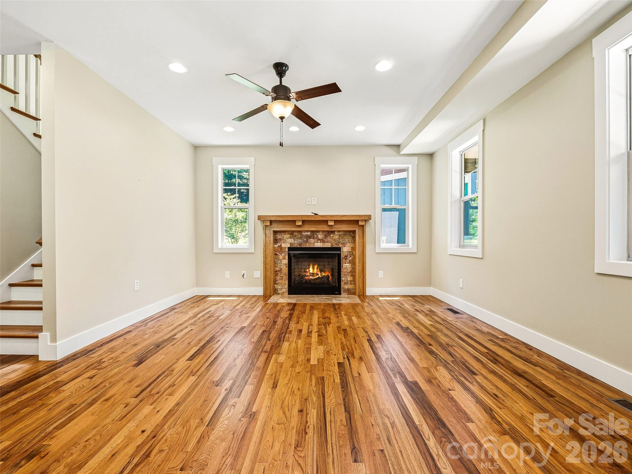 Living area with 10 ft ceilings and natural gas fireplace. - 25 Shady Park Lane, Asheville