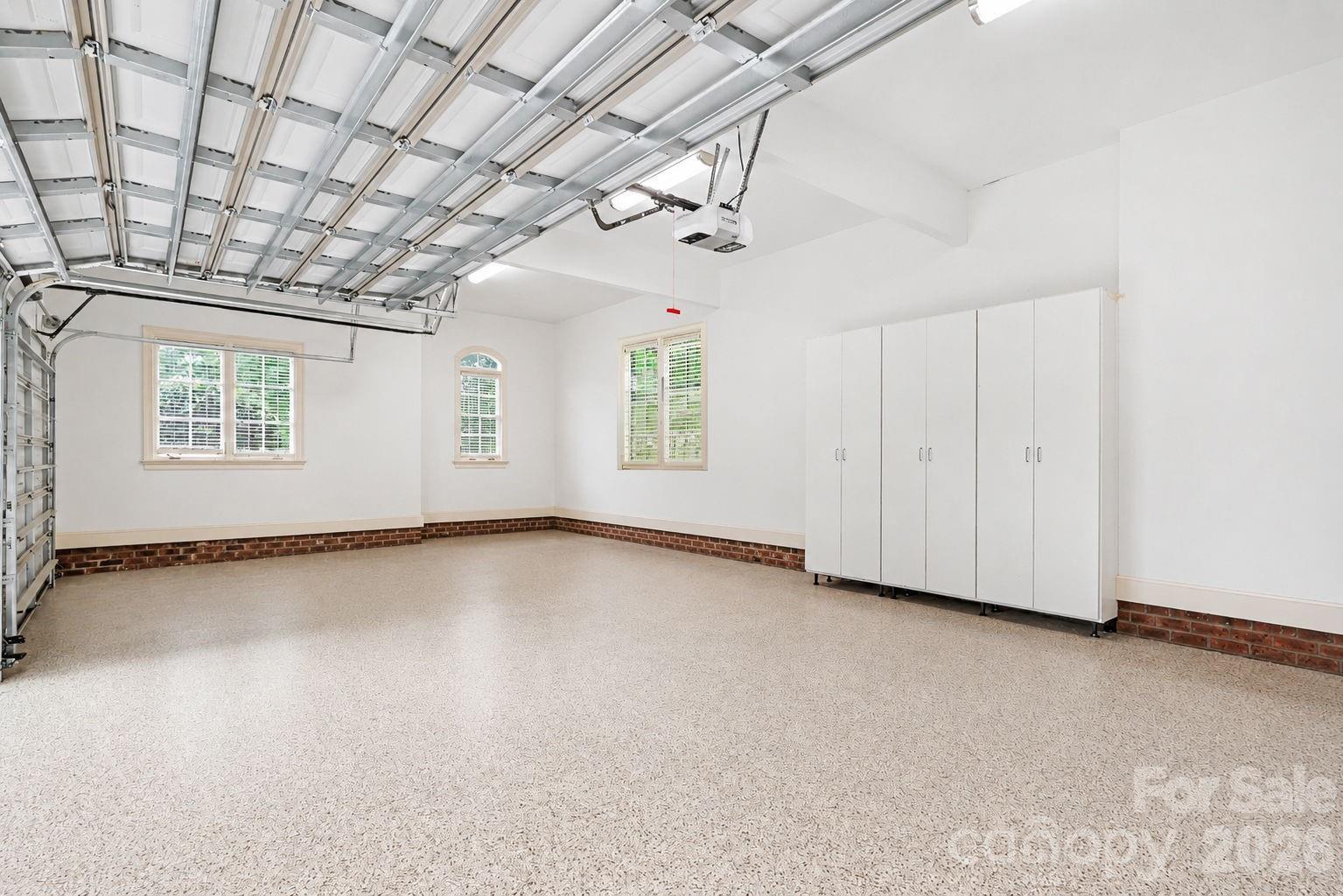 3 car garage w/ epoxy floors and cabinets. - 508 Hideaway Ridge Court, Matthews