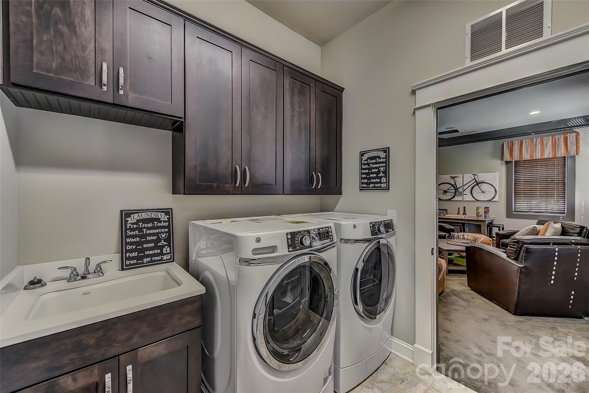 Representative Photo Laundry room with utility sink and overhead cabinets - 752 Lynderhill Lane, Matthews