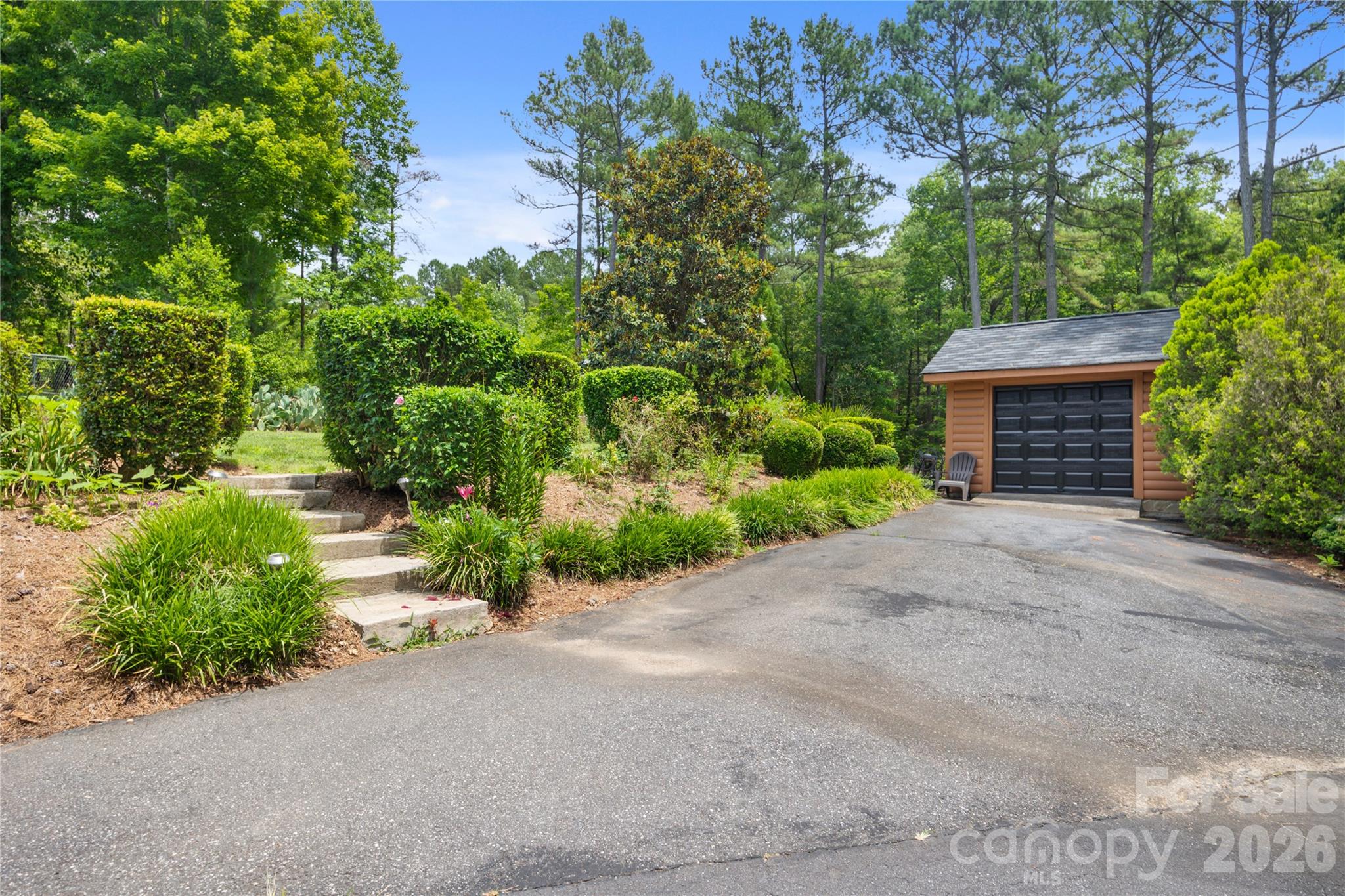 Beautifully cared-for property featuring a spacious golf cart garage. - 214 Harbor Ridge Drive, Connelly Springs